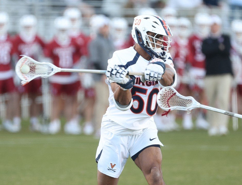 Male in white uniform playing lacrosse