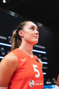 Female volleyball player in orange jersey